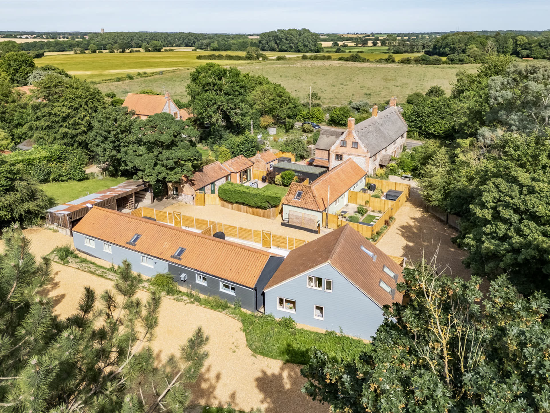 Aerial view of Thorpewood Retreats cottages and cabins set among Norfolk woodland and open countryside